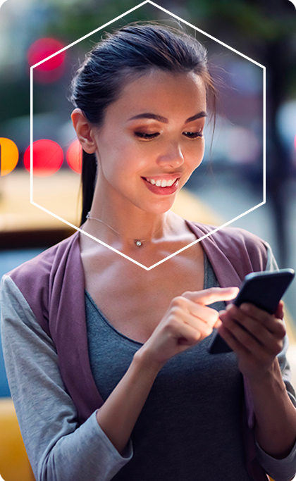 Girl on mobile device smiling with white hexagon around face