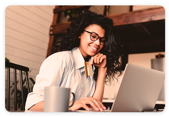 African American woman looking at laptop and smiling